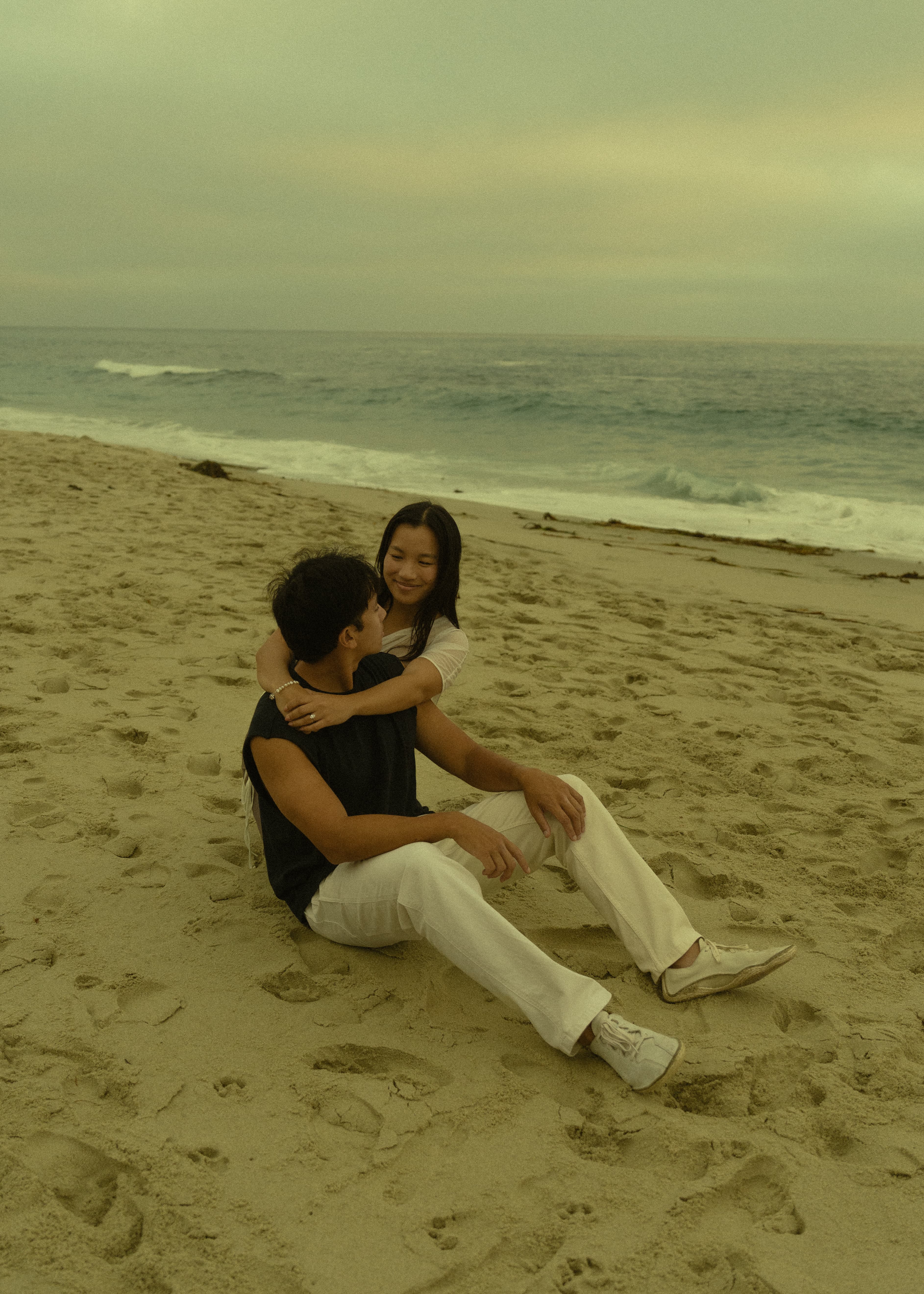 Ruth and DT sitting together on the beach