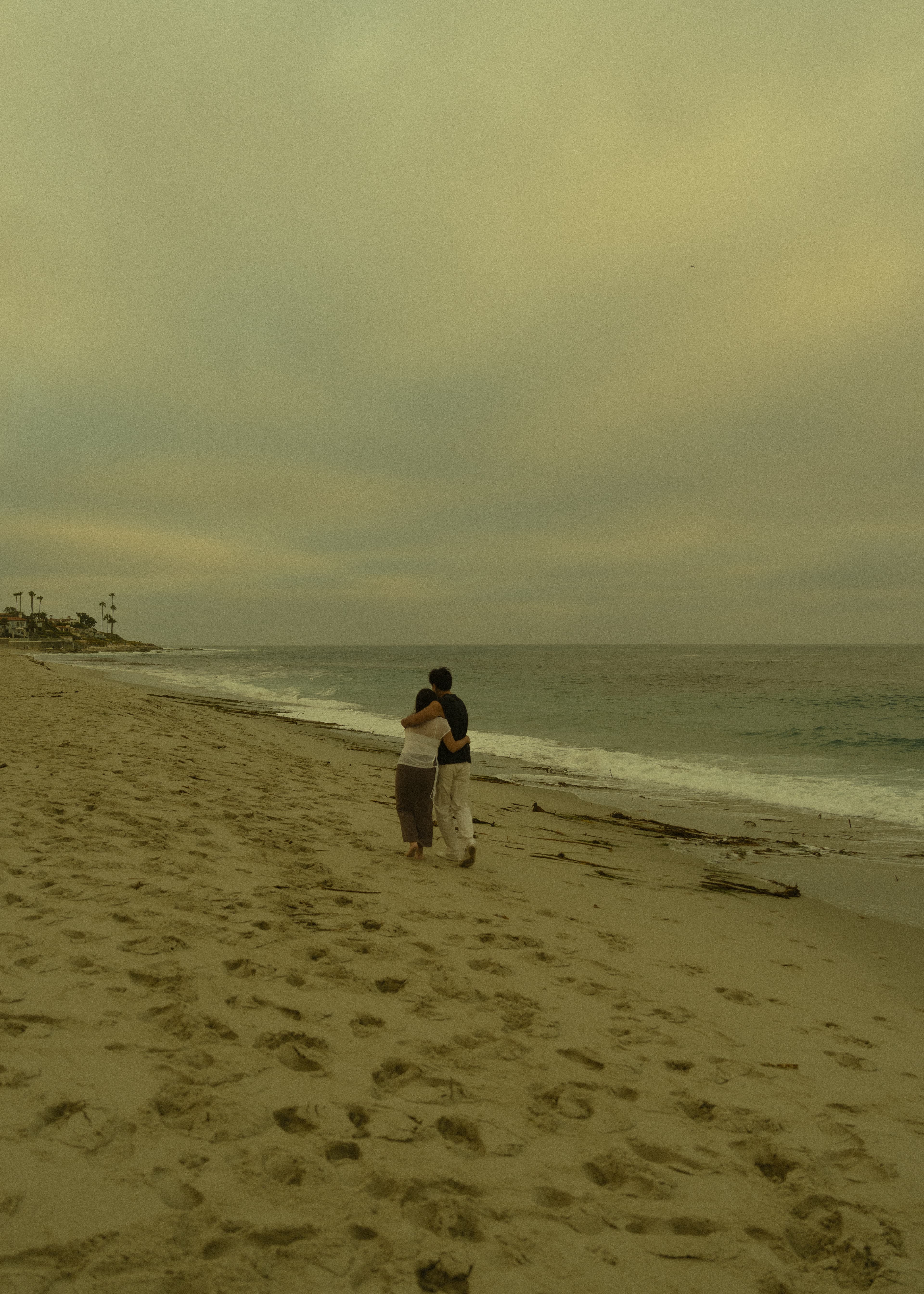 Ruth and DT walking together along the beach