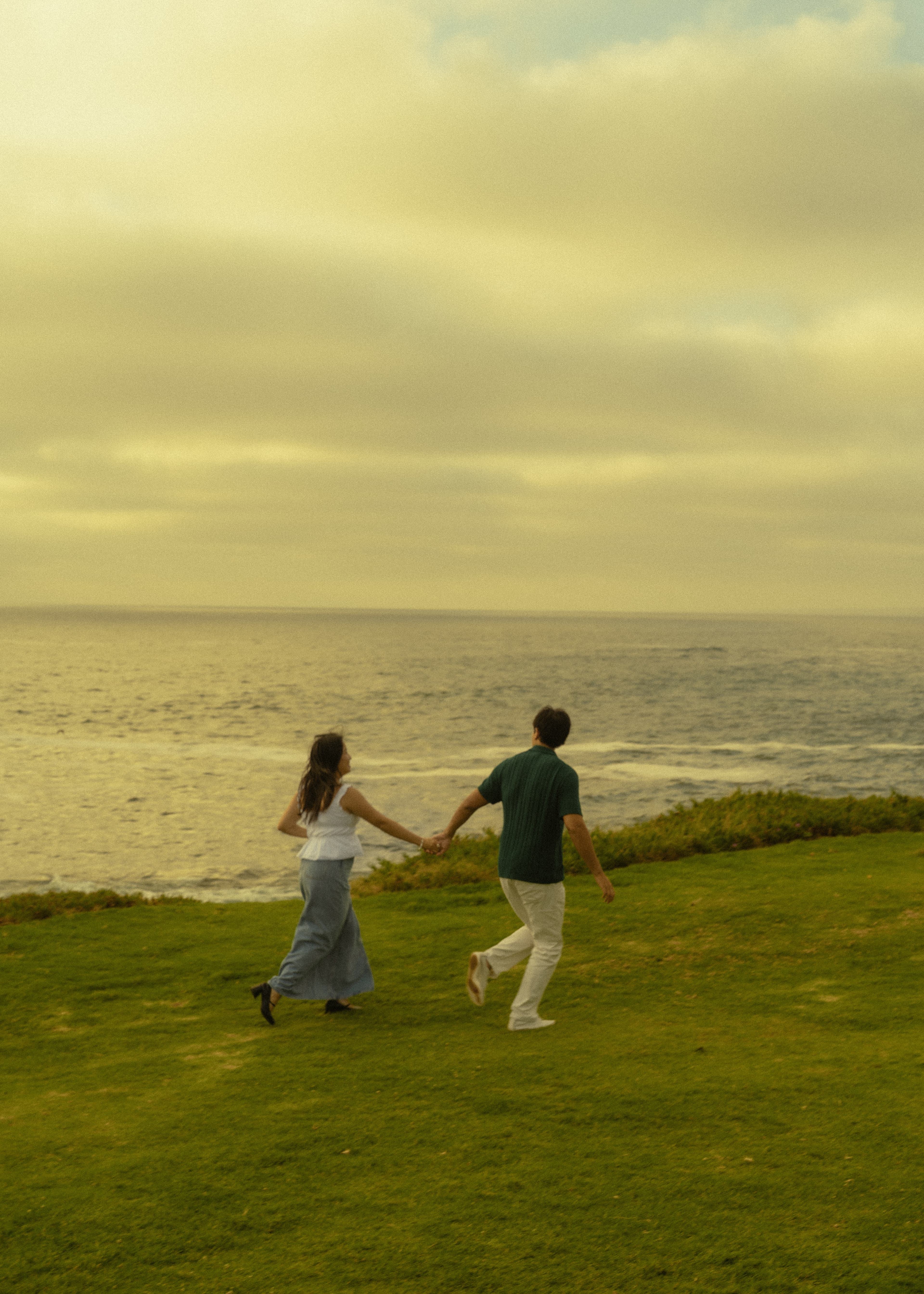 Ruth and DT running hand in hand toward the ocean