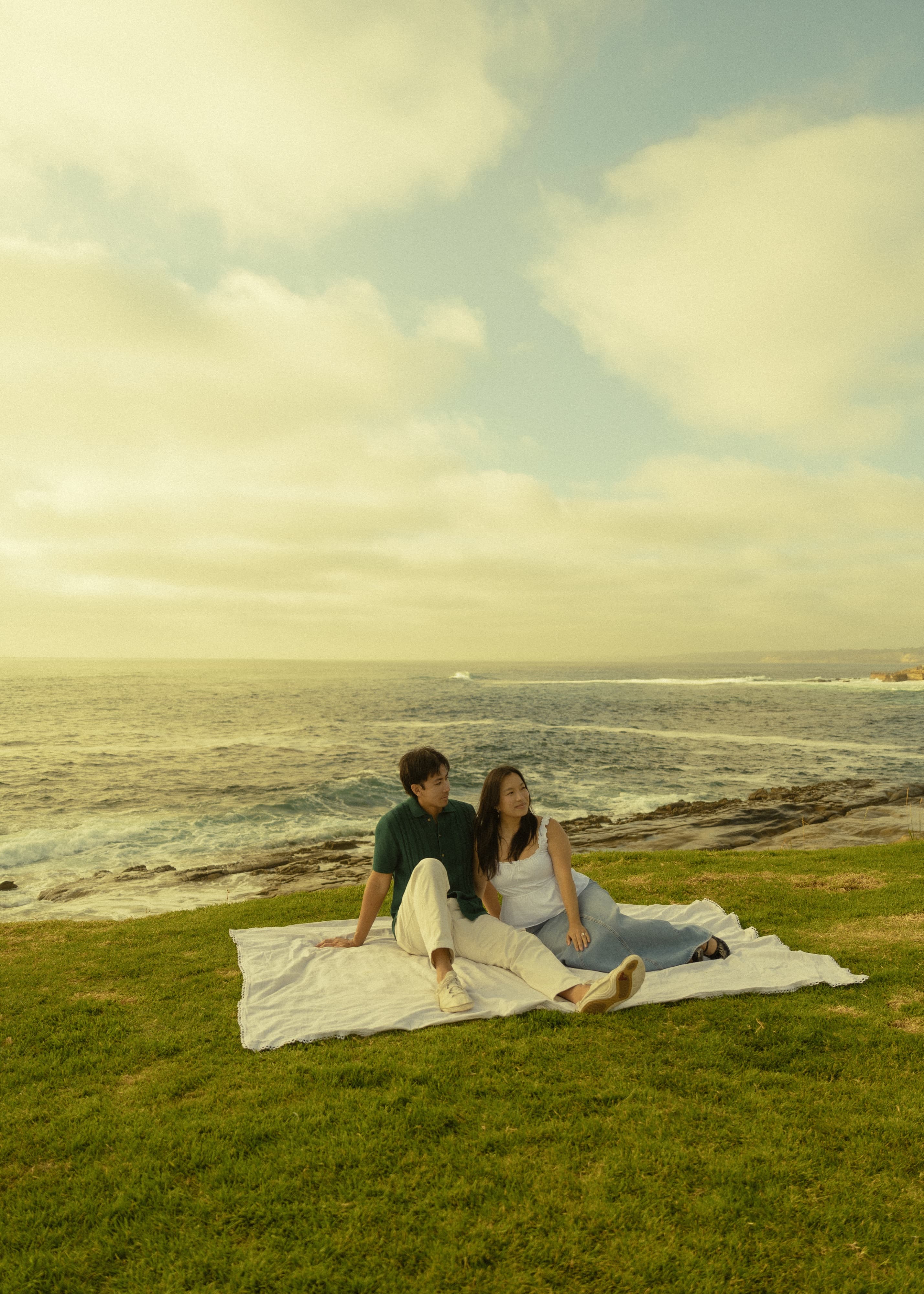 Ruth and DT seated together beside the ocean